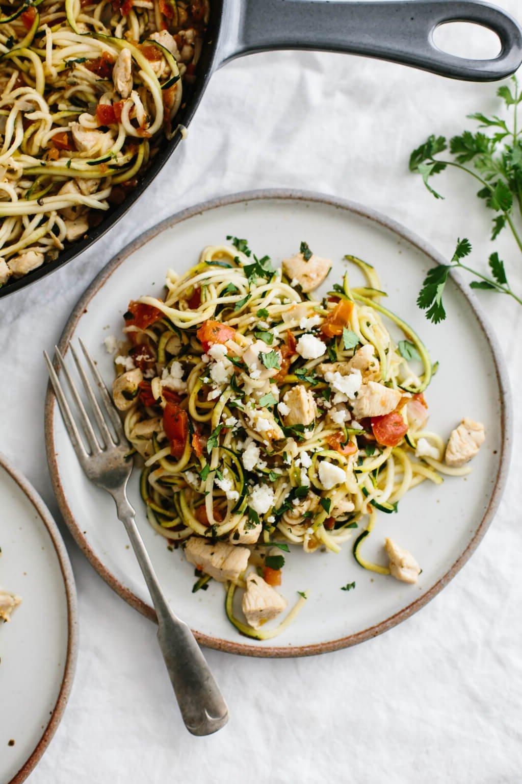 Über 20 beste Zucchini-Rezepte 13 Zucchini-Nudeln mit Hühnchen und Pico de Gallo auf einem weißen Teller.