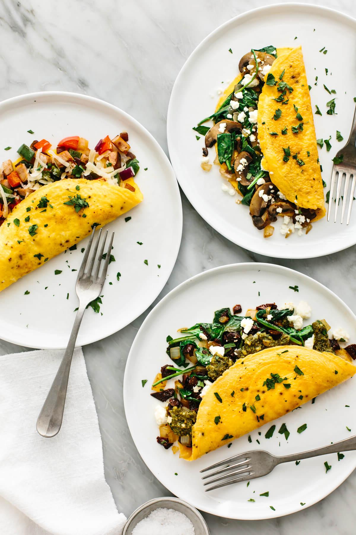 Über 40 Beste Gesunde Frühstücksideen 5 3 Omeletts auf Tellern mit Gabeln.