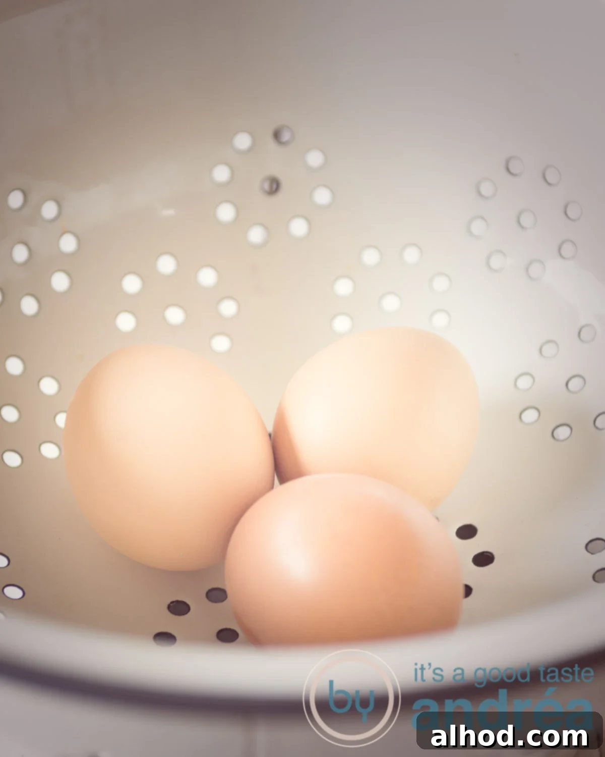 Perfect Eggs From Runny to Firm 5 Boiled eggs being transferred from a hot pan into a colander under running cold water.