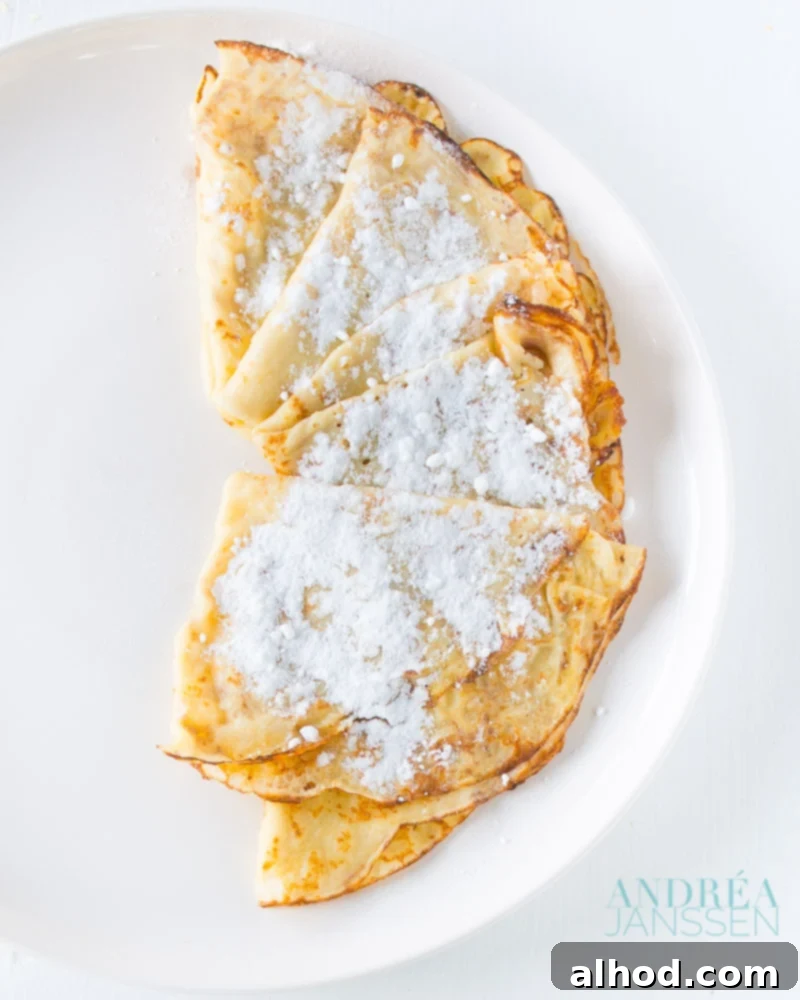 Essential Crêpe Recipe 2 Beautifully prepared crêpes, lightly golden and ready to be served, perfect for a French lunch or elegant dessert.