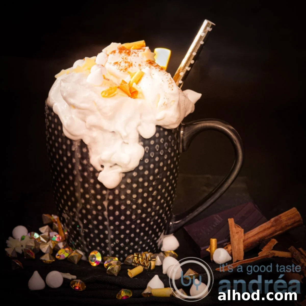 11 Festive Sips to Brighten Your Christmas 9 A square photo of a black mug with whipped cream, golden chocolate curls and cinnamon marshmallows on the black background.