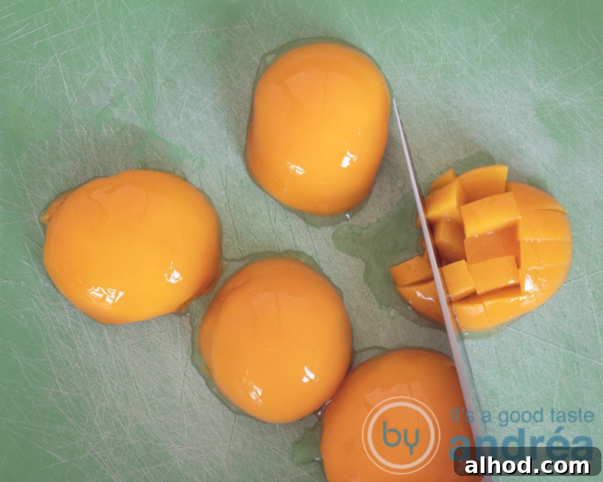 Eggnog Tiramisu with Peaches 4 Close-up of fresh peaches being sliced into small cubes on a cutting board, preparing them for the tiramisu layers.