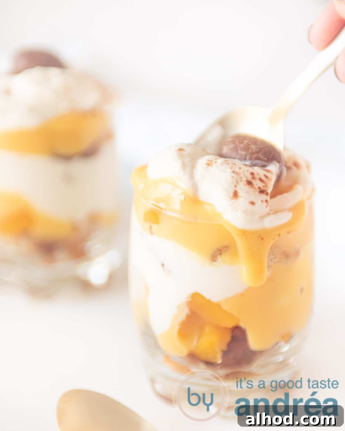 Eggnog Tiramisu with Peaches 8 A beautifully presented glass of quick tiramisu with eggnog and peaches, garnished with cocoa powder and a chocolate egg, ready for a festive celebration.