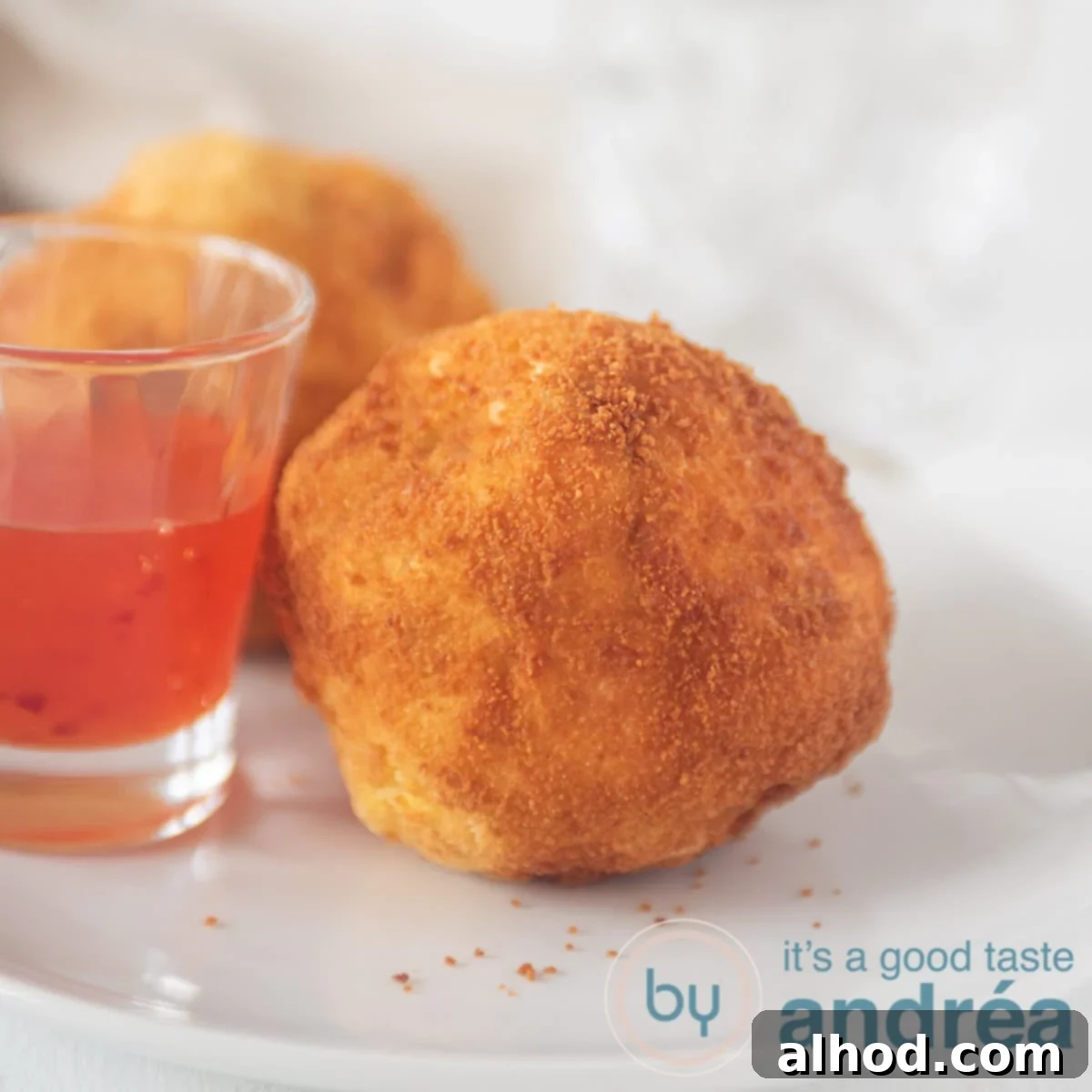 Homemade Beef Papa Rellena 10 a square photo with papas rellenas and a glass filled with chili sauce