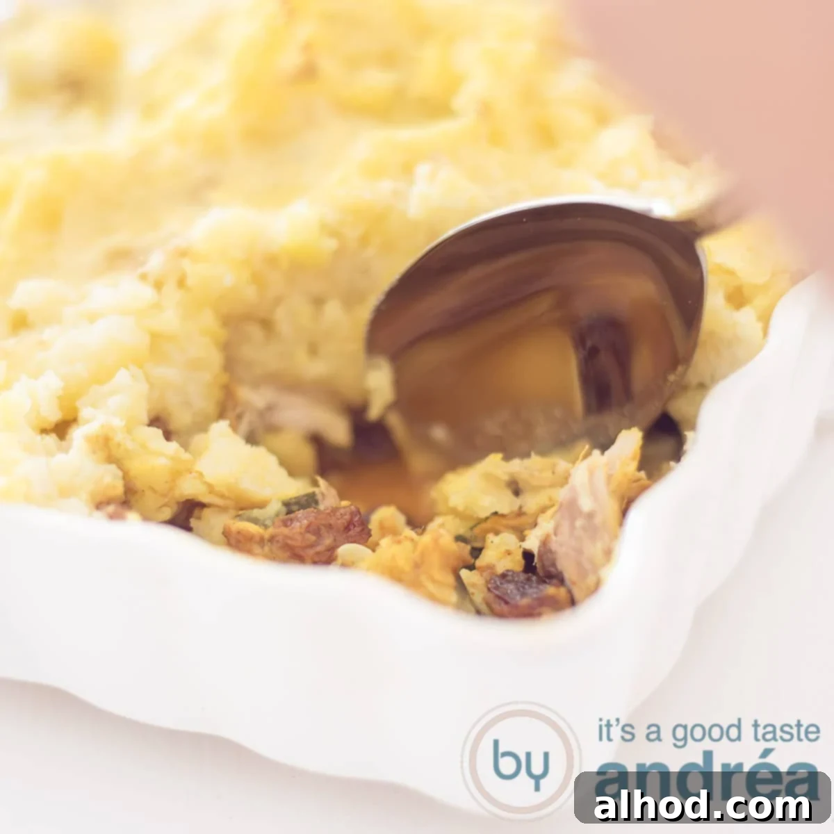 Smoked Mackerel and Zucchini Potato Bake 6 A square photo with part of a white casserole filled with mackerel, zucchini and mashed potatoes