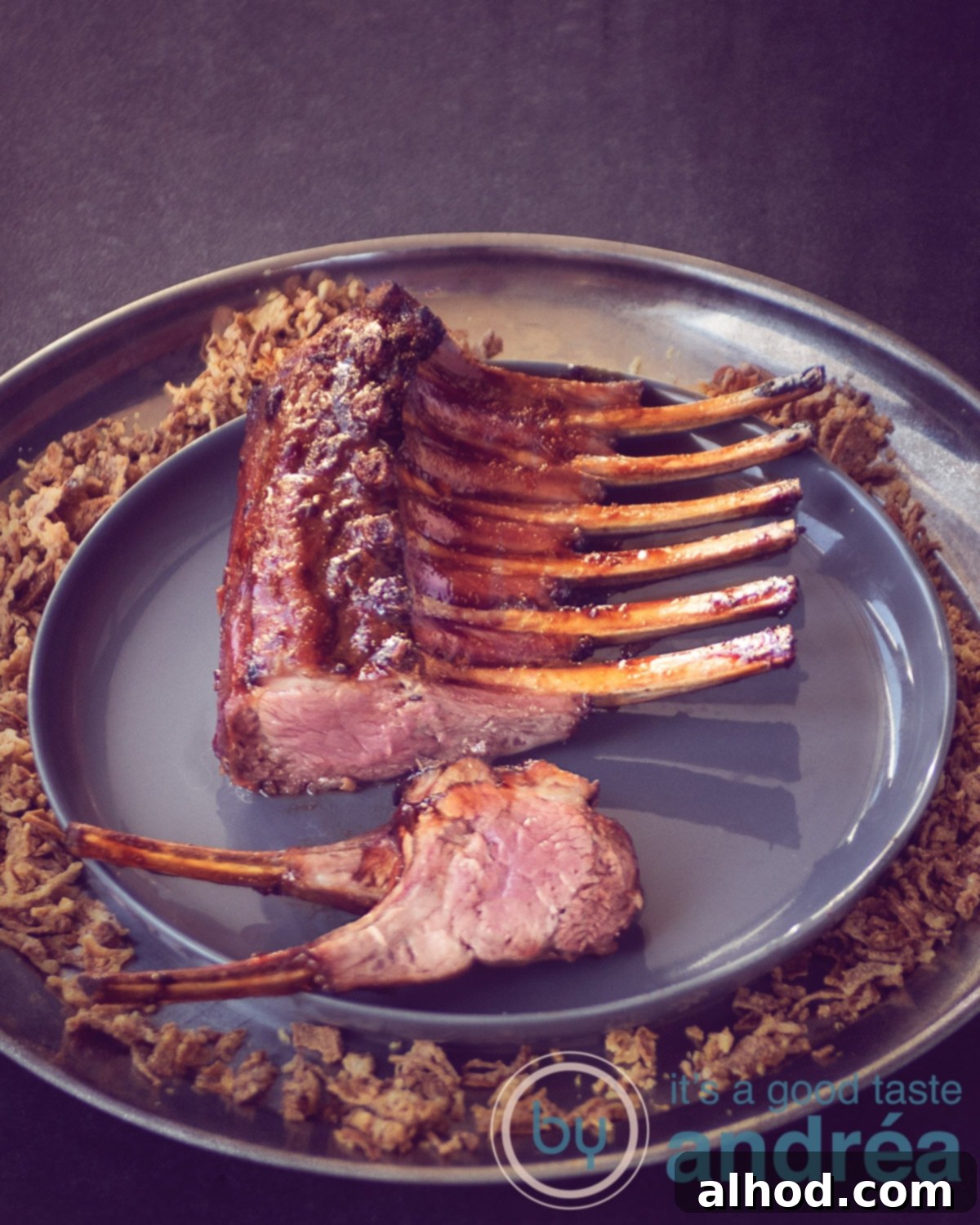 Beautifully presented Asian Rack of Lamb on a round plate, ready to serve