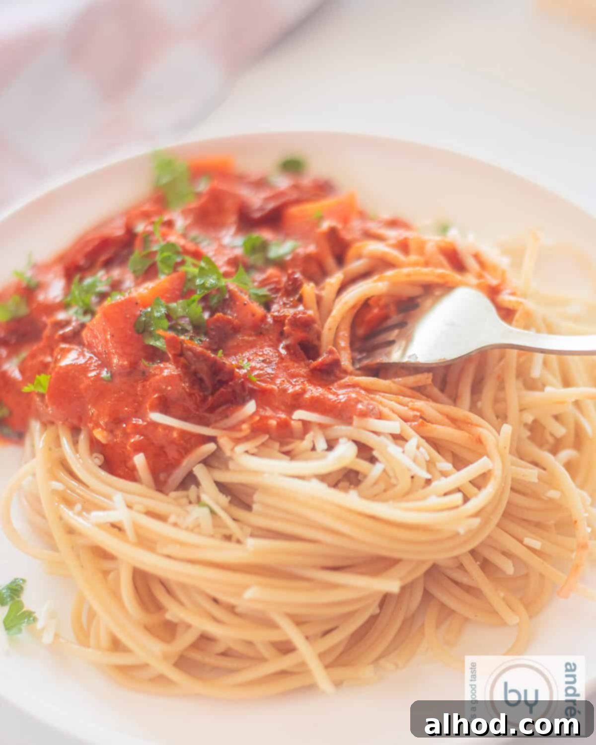 Creamy Mascarpone Ground Beef Spaghetti in 25 Minutes 2 A photo of a white plate with a mountain of spaghetti with tomato sauce, minced meat and mascarpone
