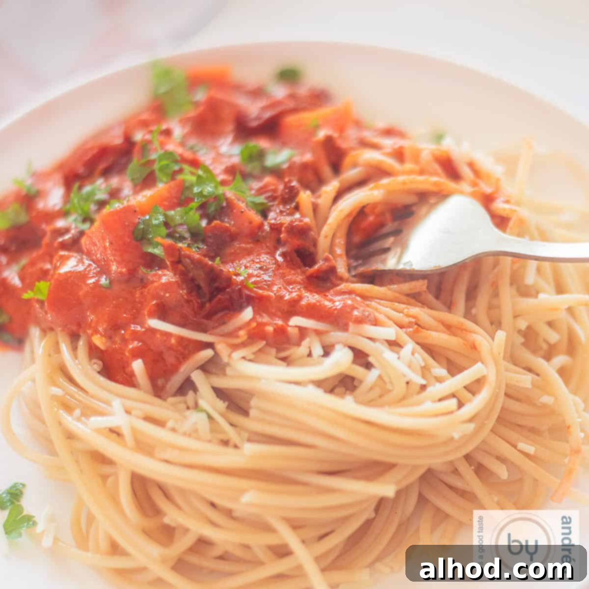 Creamy Mascarpone Ground Beef Spaghetti in 25 Minutes 4 A square photo with a plate of spaghetti with sauce containing mascarpone, ground beef and tomato.