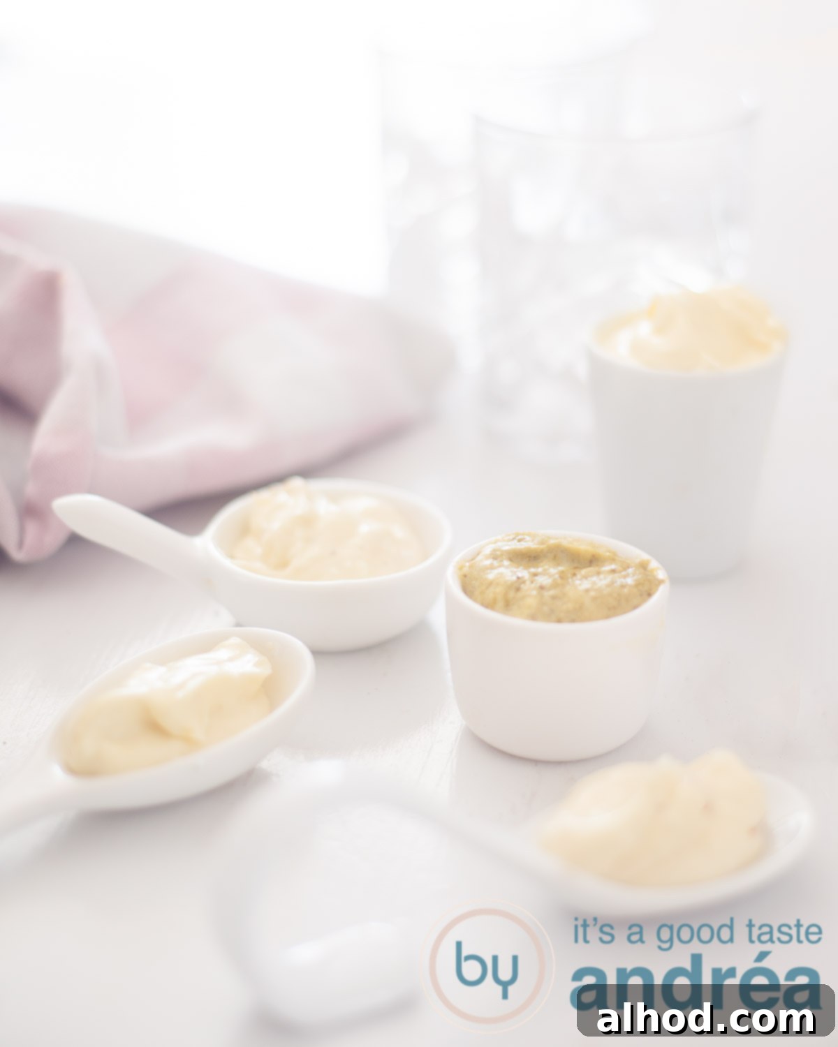Upgrade Your Mayo: 5 Delicious Flavor Infusions 13 5 bowls filled with different mayonnaise varieties on a white background