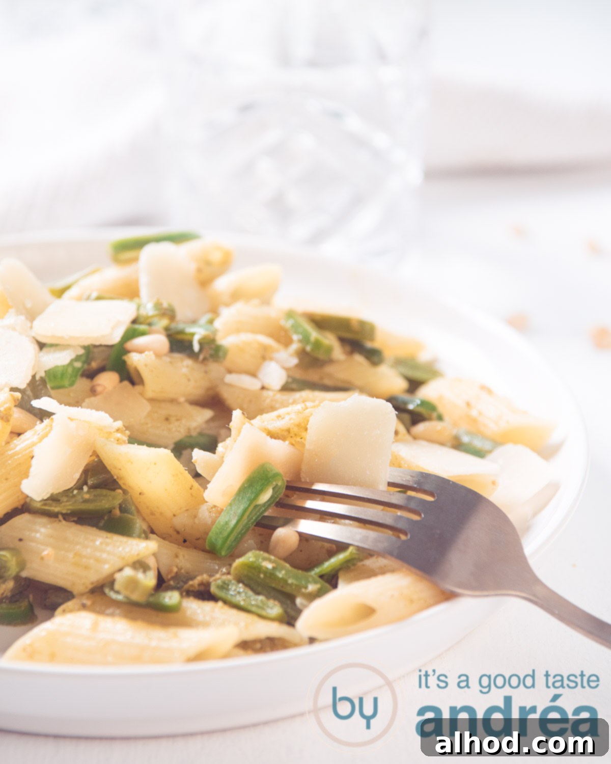Fresh Runner Bean Pesto Pasta 5 Runner Beans, penne and pesto on a white plate with a golden fork. Everything on a white background