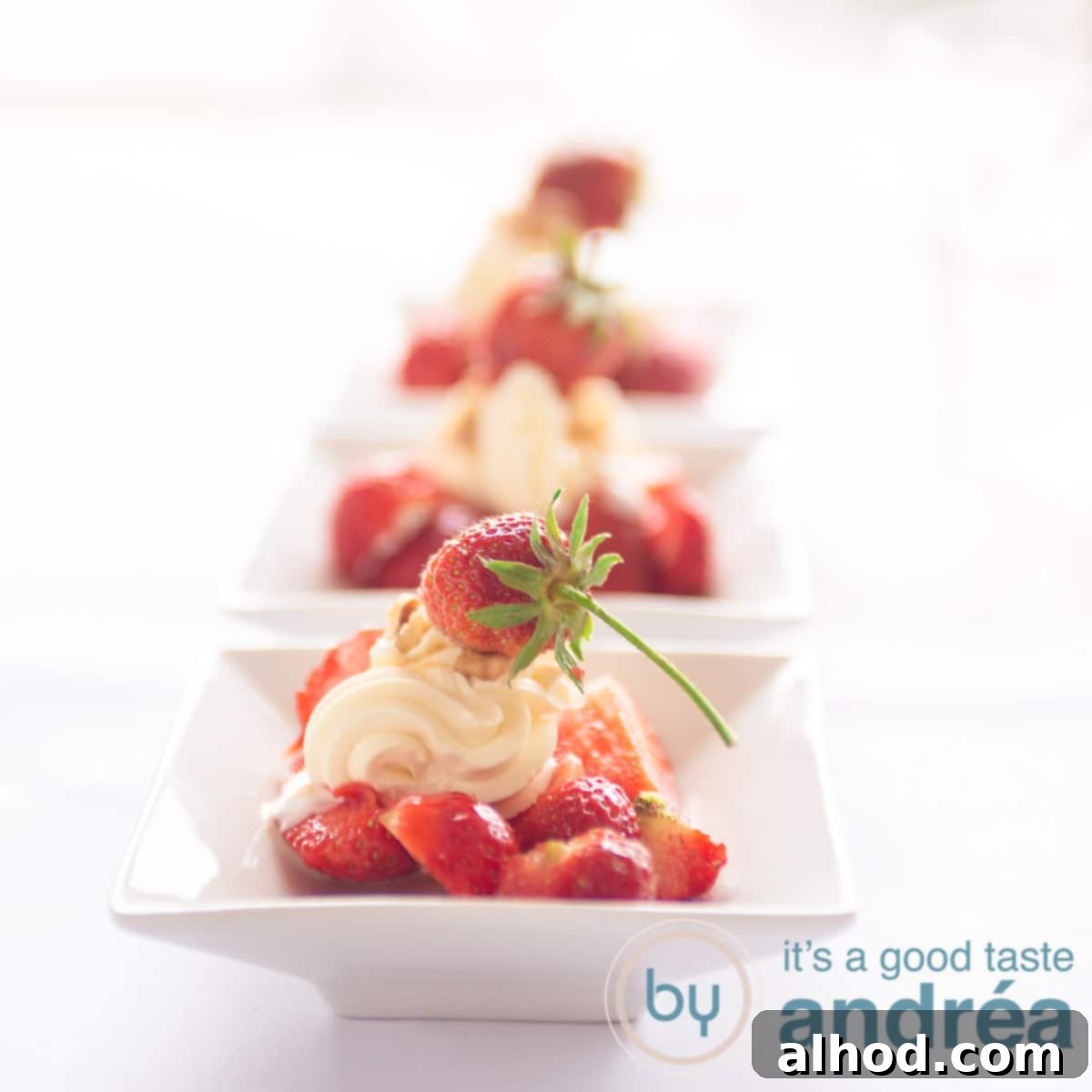 3-Ingredient Strawberry Cream Cheese Dream 6 A square photo with three white bowls filled with strawberries, walnuts and cream cheese. Topped with a strawberry