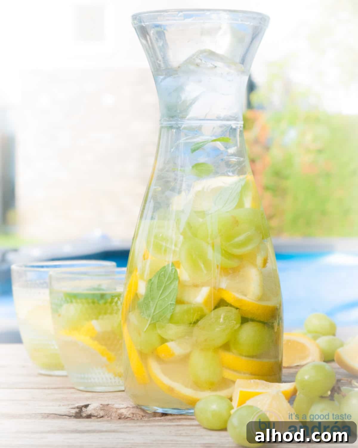 Flavorful Grape Infusion 3 Delicious grape and lemon infused water with fruit slices and ice, served on a rustic wooden table.