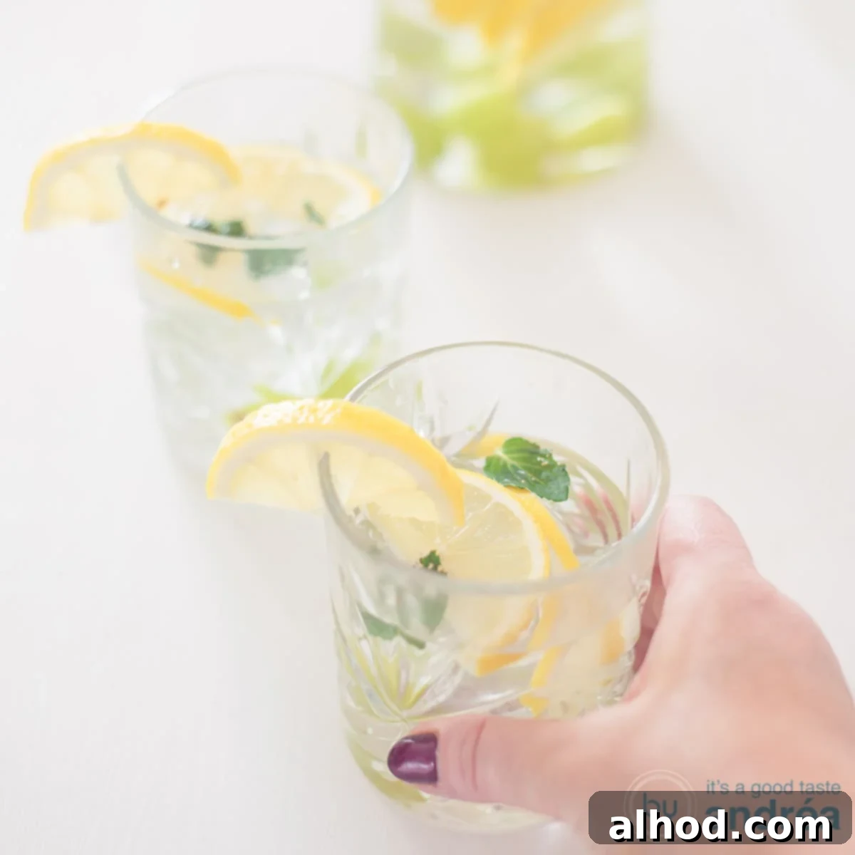 Flavorful Grape Infusion 4 Two glasses of vibrant grape and lemon infused water, ready to serve on a clean white background.