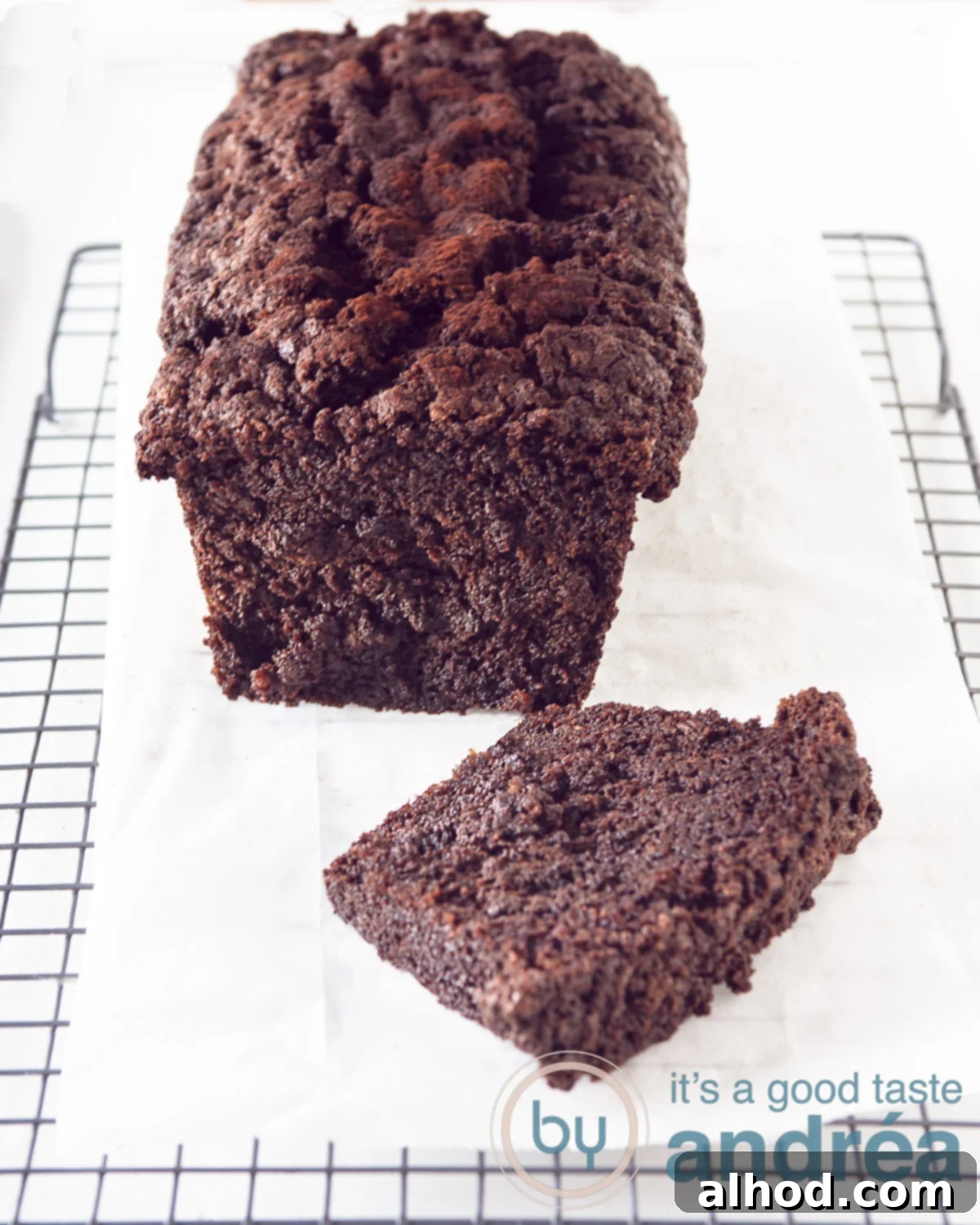Decadent Dark Chocolate Zucchini Cake 2 Chocolate zucchini cake on baking paper on a rack