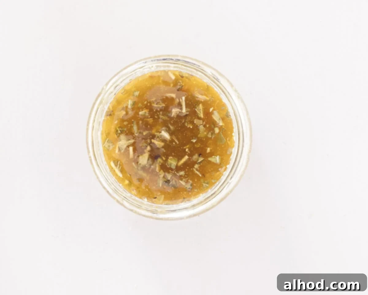 Zesty Italian Veggie Pasta Salad 5 A glass jar filled with Italian dressing