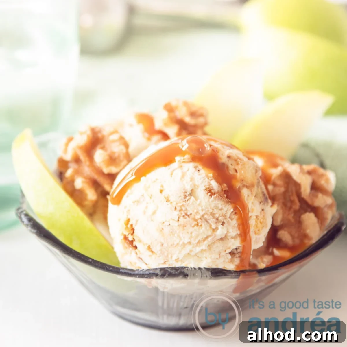 Easy Apple Pie Ice Cream 6 A square photo of a bowl with ice cream, apples, walnuts on a white background