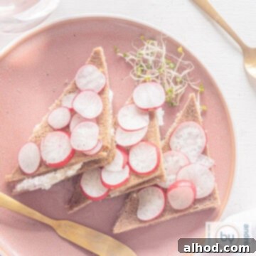 Exquisite High Tea: Four Sandwiches for a Lasting Impression 6 A beautifully presented square rye bread tea sandwich topped with creamy radish spread and fresh herbs.