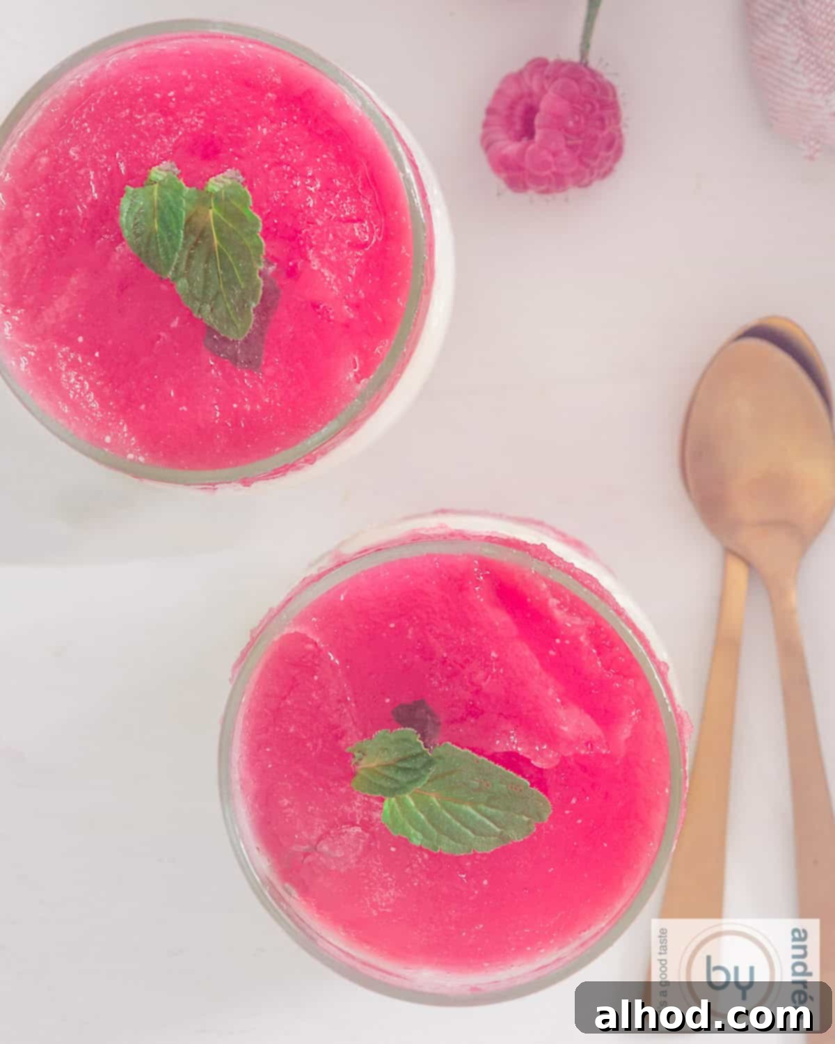 Frosted Lime Yogurt with Raspberry Mint Glaze 3 An overhead photo of a dessert with yogurt ice cream and raspberry jelly topping and mint.