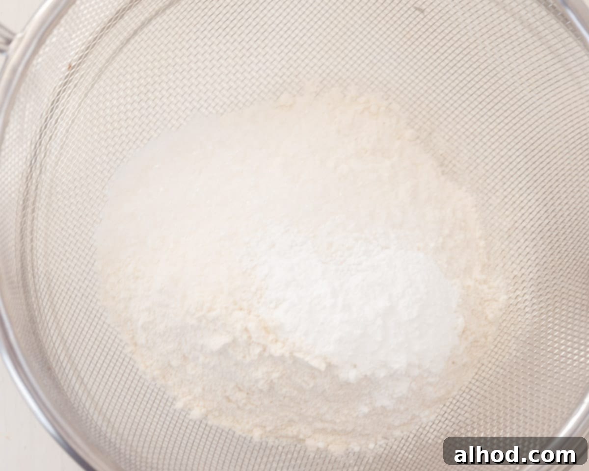 Strawberry and Cream Scones 4 The ingredients are sieved into a glass bowl.