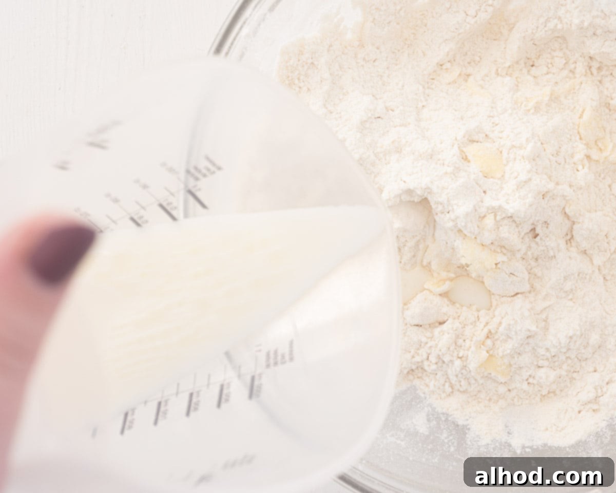 Strawberry Cream Scones A British Classic 5 Milk is poured with the ingredients.