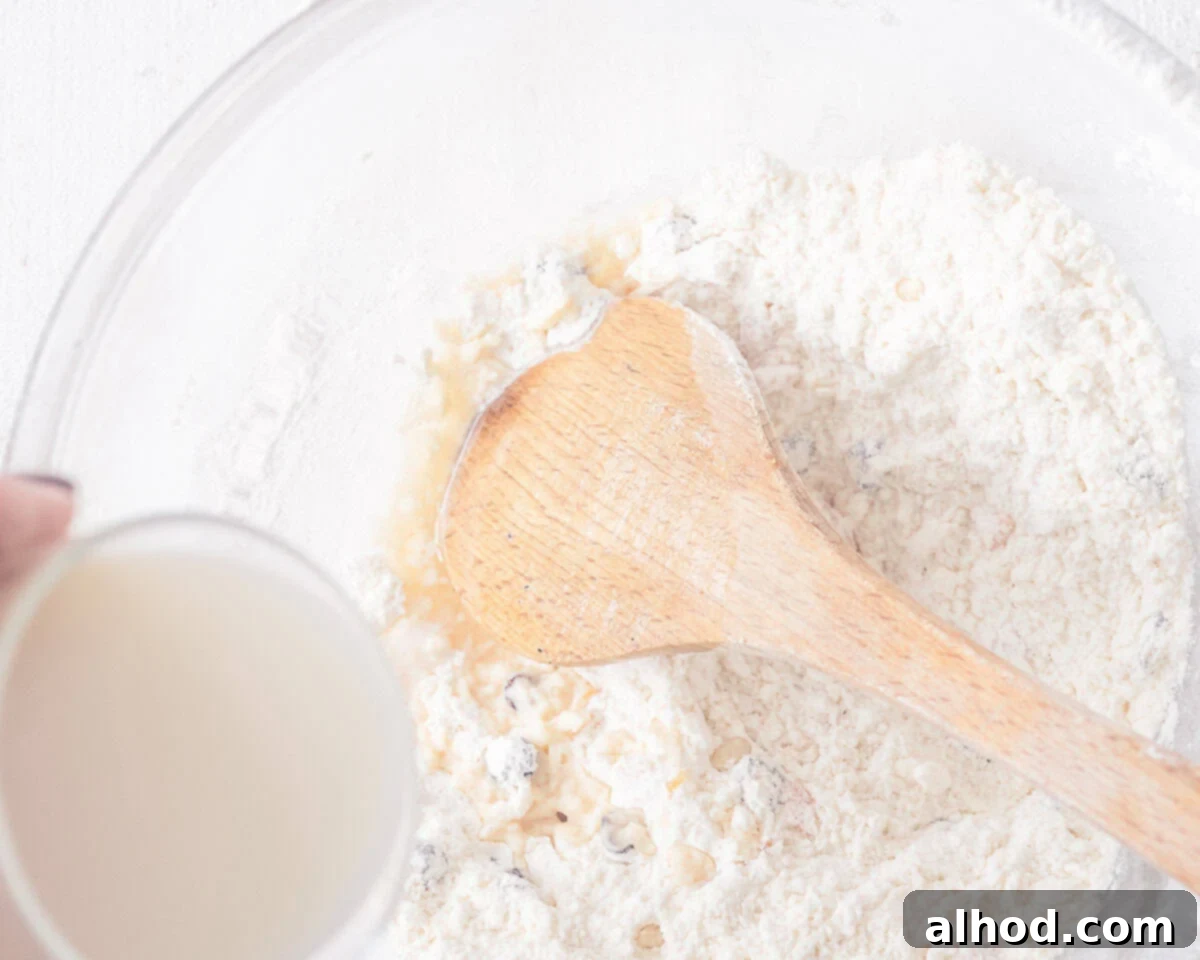 Milk is added to the dry ingredeints in a glass bowl.