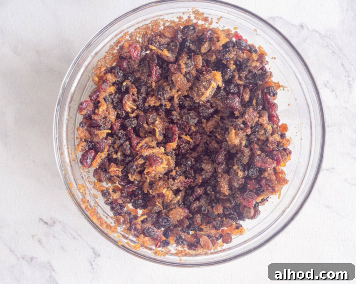 Decadent Hazelnut Mince Pies 5 Fruit mince mixture in a clear glass bowl, showcasing the rich, dark fruit and spices.