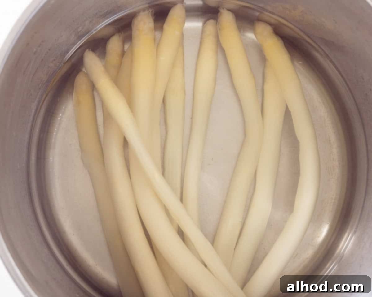 Effortless Asparagus Pasta with Poached Egg 4 A pan with white asparagus being cooked