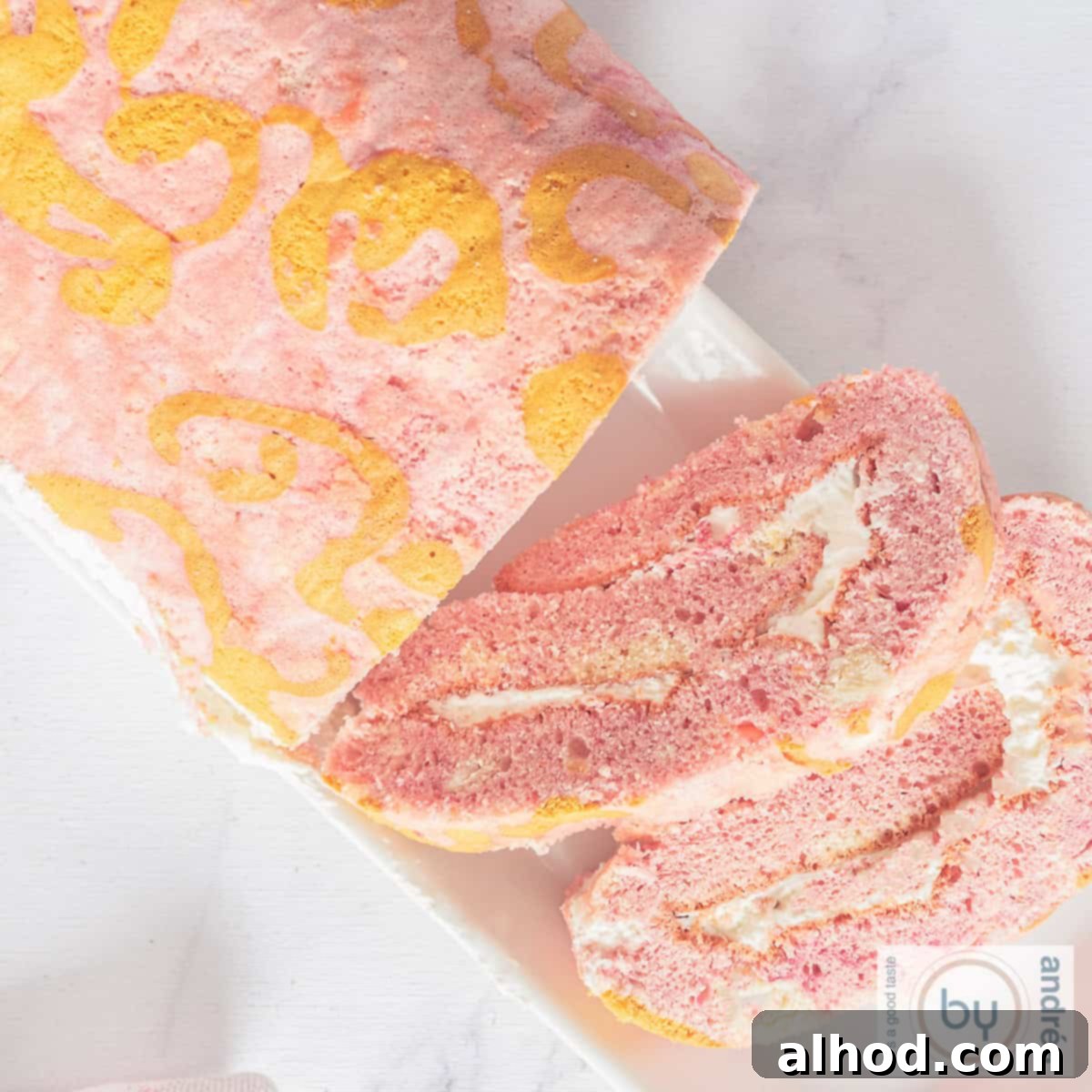 A square overhead photo of a beautifully rolled Swiss roll cake with a generous layer of whipped cream filling visible.