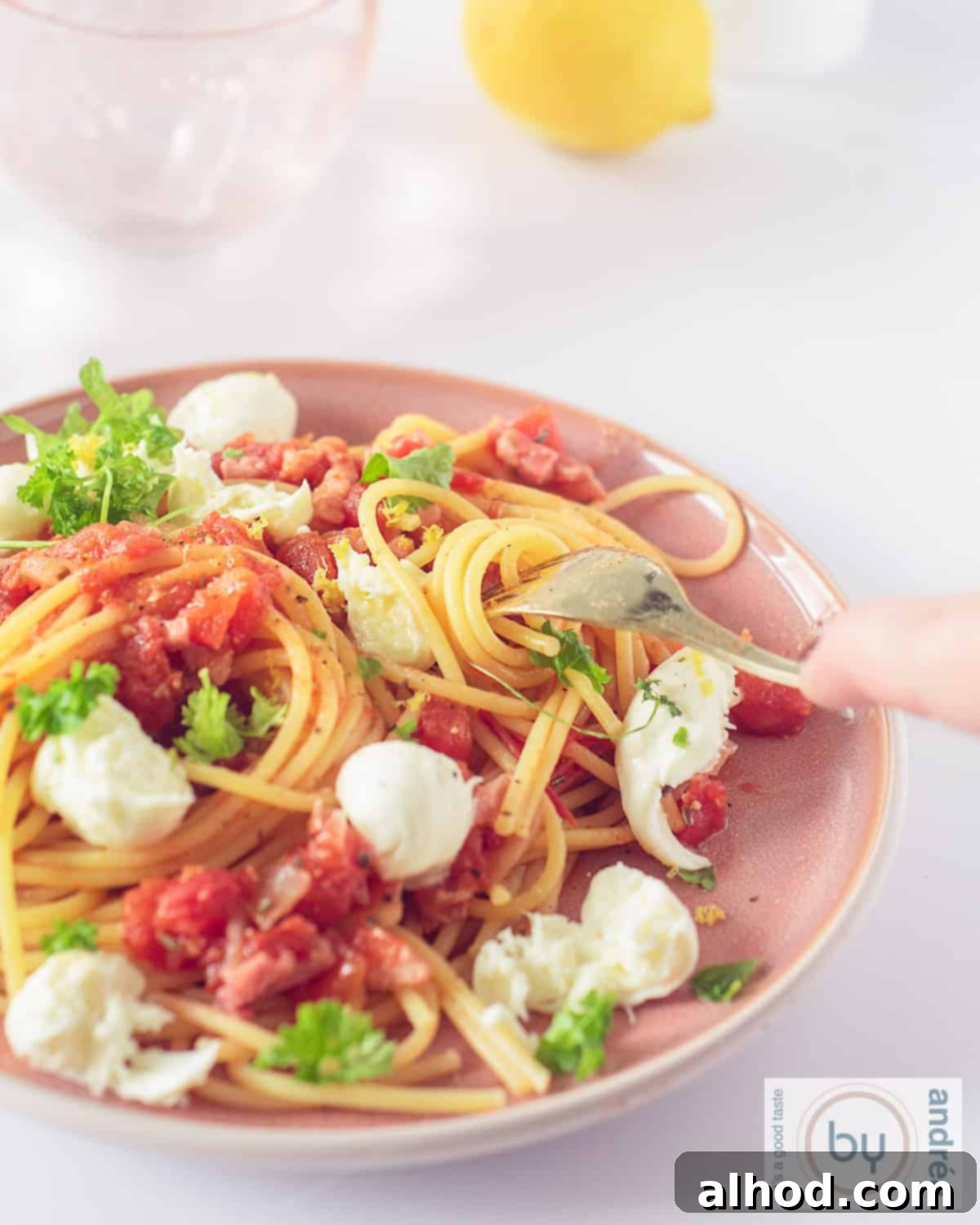 Savory Bacon, Tomato, and Mozzarella Spaghetti 2 A pink plate with spaghetti, tomatoes, mozzarella and bacon.