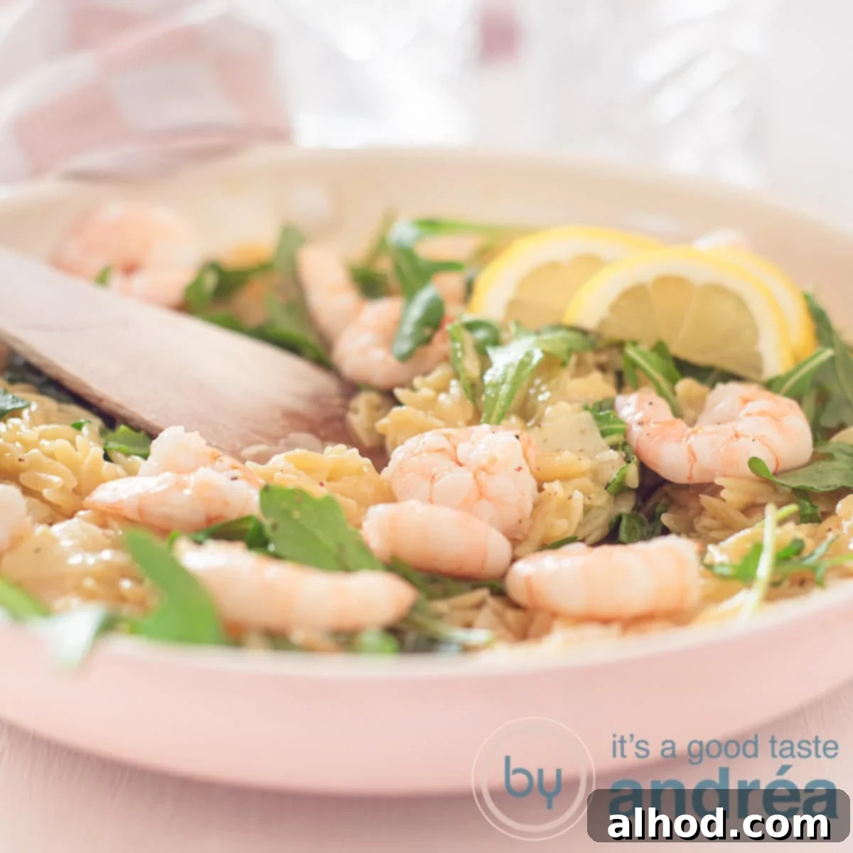 Zesty Lemon and Parmesan Arugula Risotto 6 A square photo with a frying pan with risotto, shrimp and arugula.