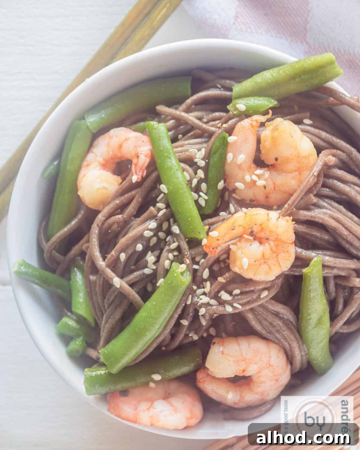 Shrimp and Green Bean Soba Ready in 20 Minutes 3 A bright, overhead shot of a white bowl overflowing with vibrant soba noodles, plump shrimp, crisp green beans, and a generous sprinkle of toasted sesame seeds, perfectly arranged for a healthy and delicious meal.
