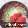 Loaded Nacho Beef Bake 7 Vegetables are added to the seasoned minced meat in a frying pan.
