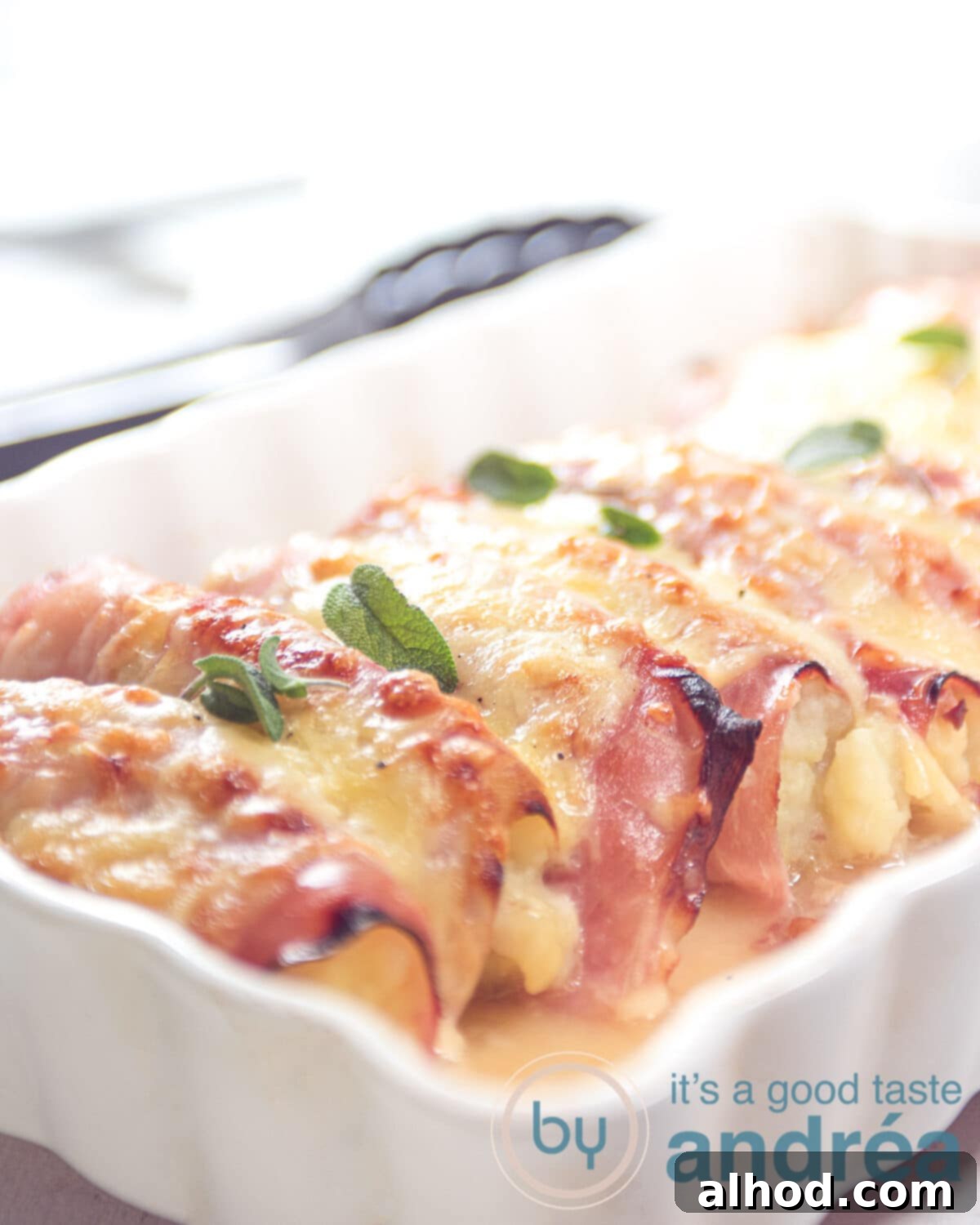 Kid-Friendly Belgian Endive Casserole 8 a part of a casserole dish with chicory potato mash ham rolls