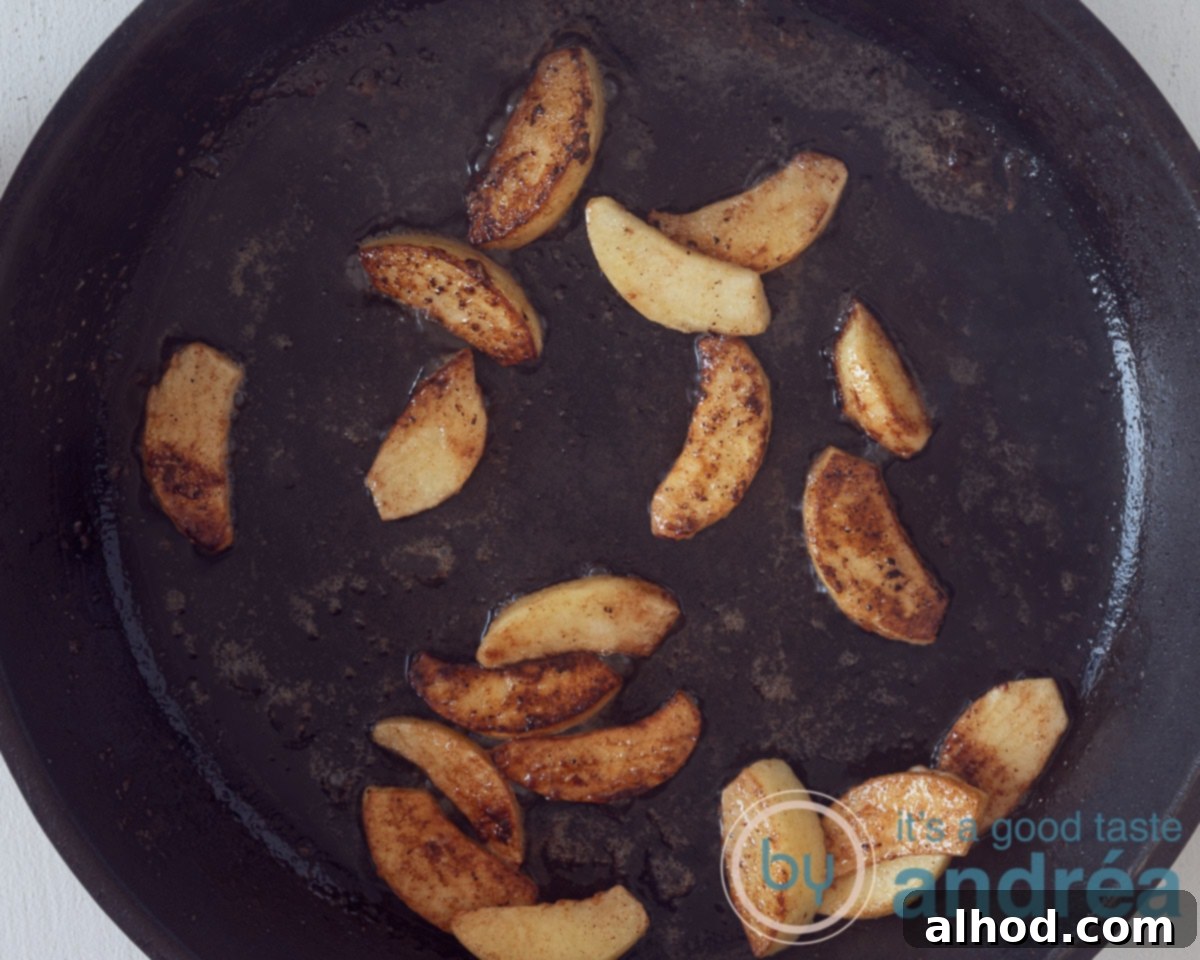 Apple Pie Jars 5 Frying apple slices in a frying pan with butter and sugar until caramelized.