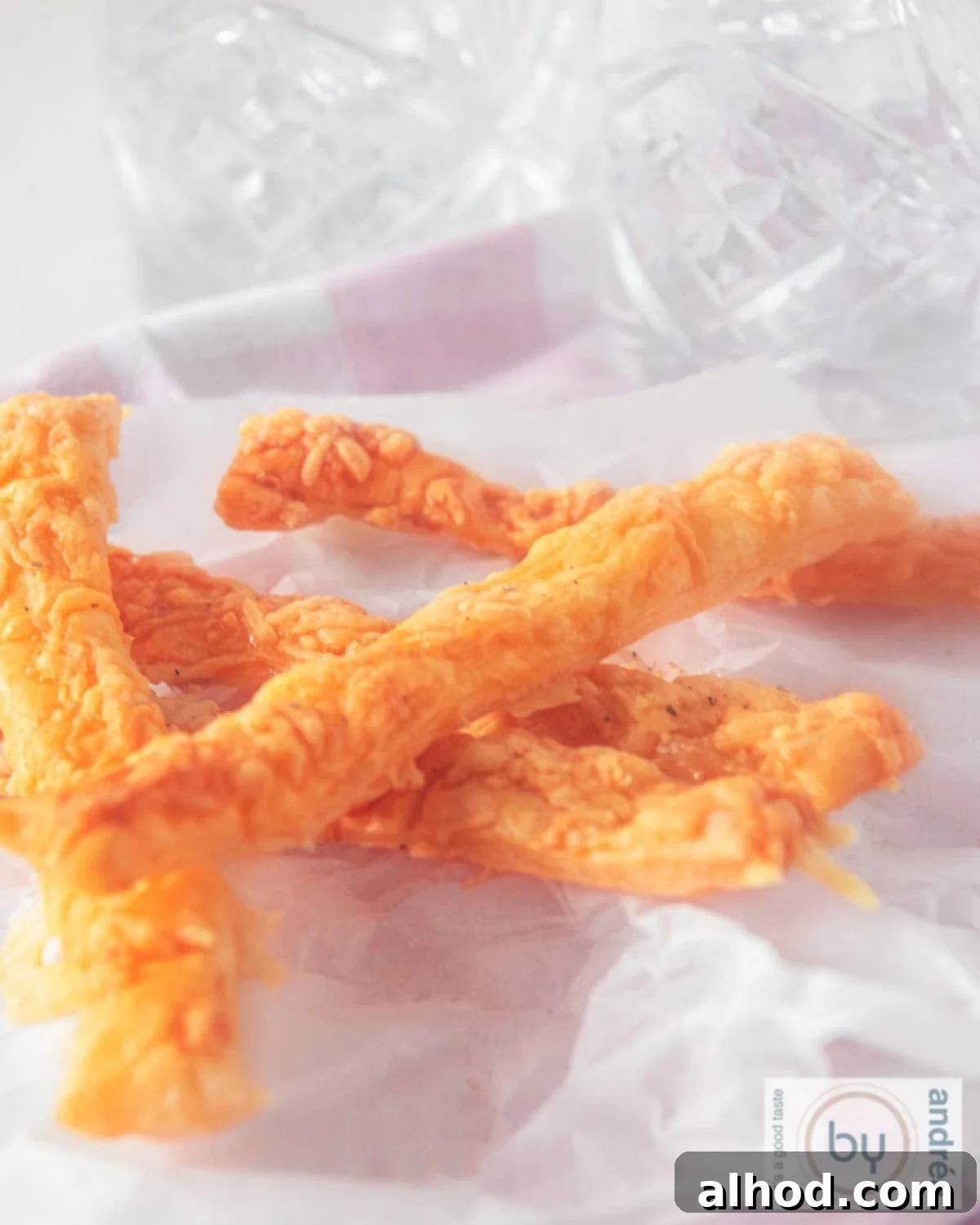 Easy 3 Ingredient Parmesan Puff Pastry Sticks 3 A baking sheet with puff pastry cheese sticks on it.