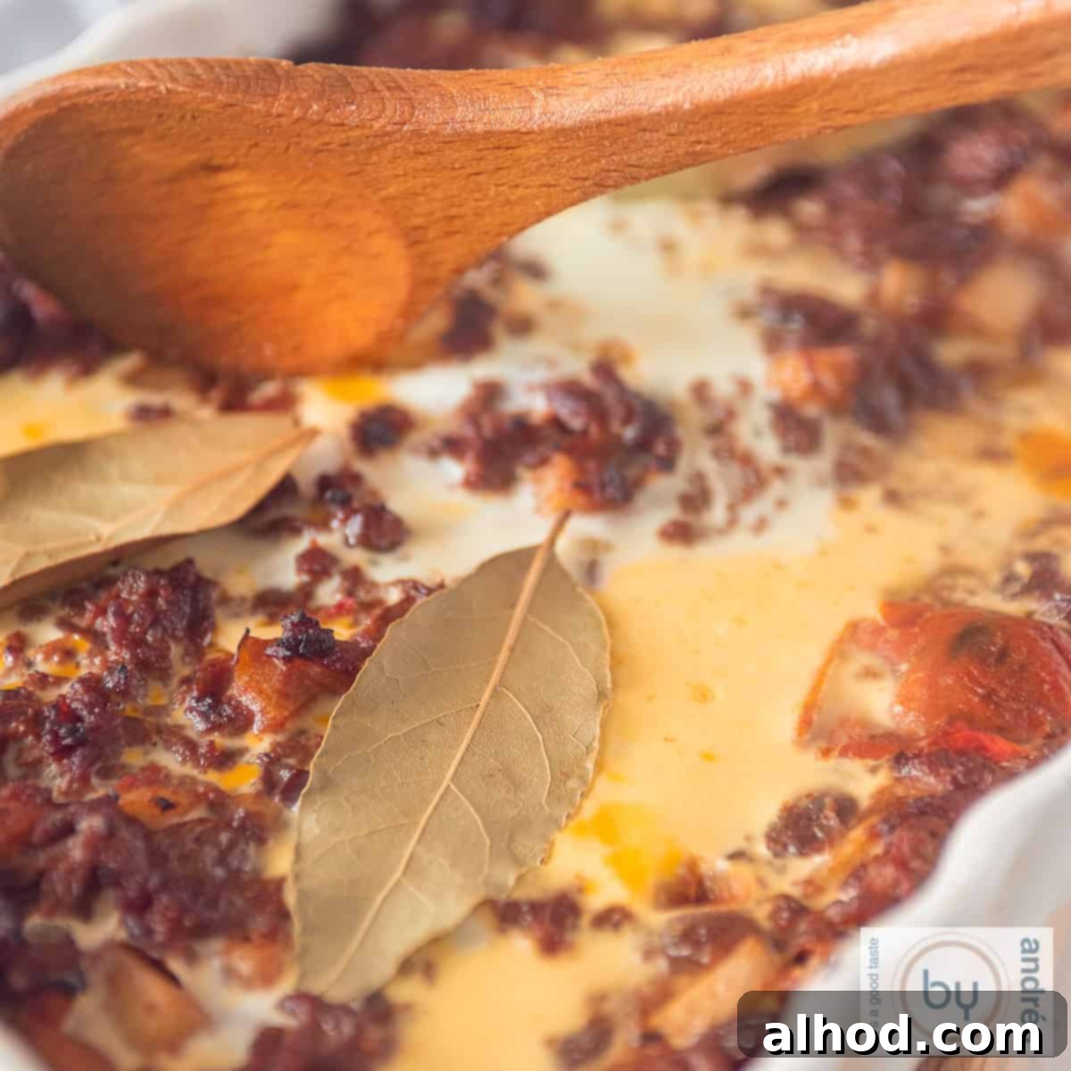 Classic South African Bobotie Beef with Sweet Fruit 4 A square photo of a bobotie casserole with minced meat, bay leaves, egg, apple and raisins.