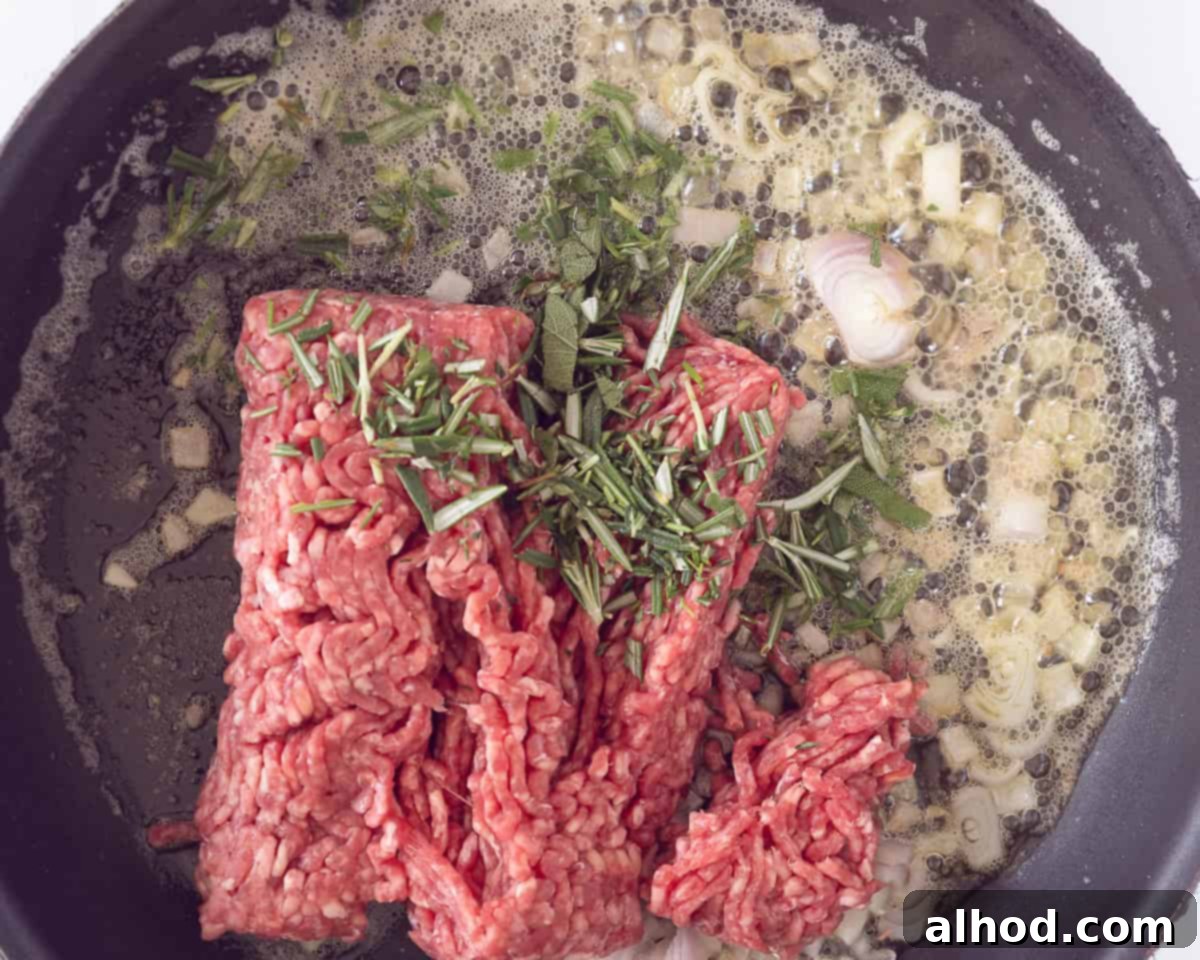 Hearty Beef and Potato Comfort Bake 5 In a skillet, shallot, fresh herbs, butter and ground beef are fried.