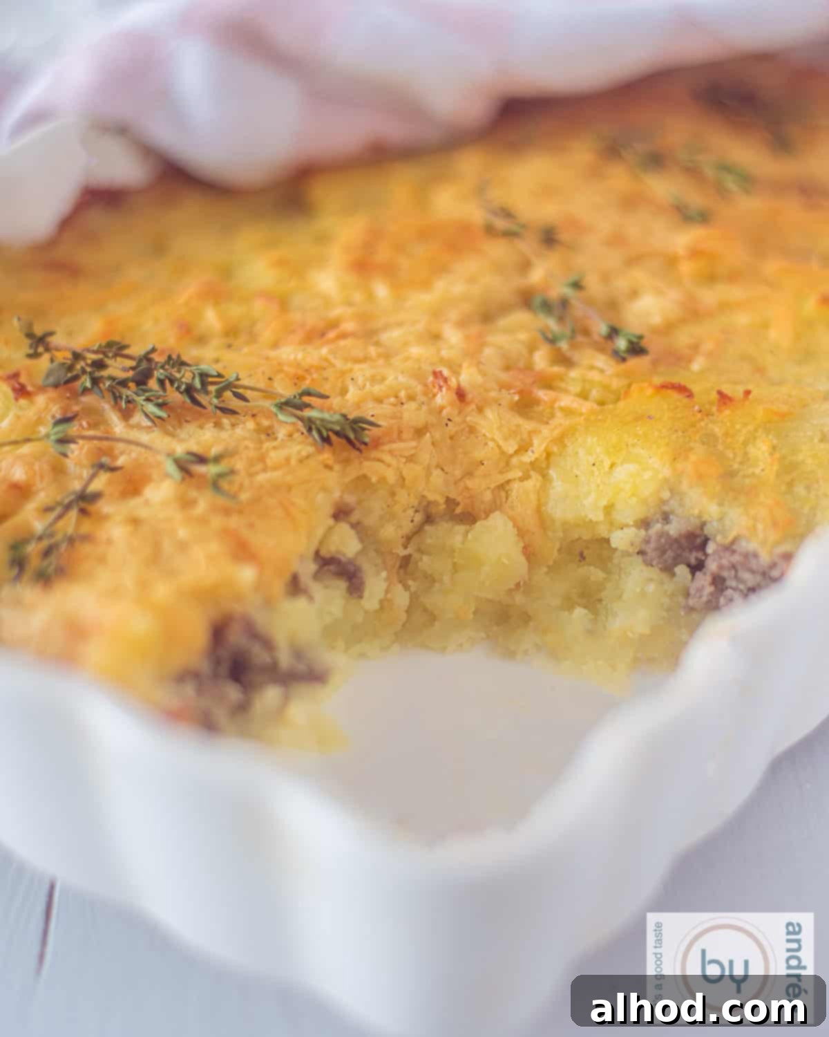 Hearty Beef and Potato Comfort Bake 8 A height picture of a ground beef and mashed potato casserole. A scoop is taken out.