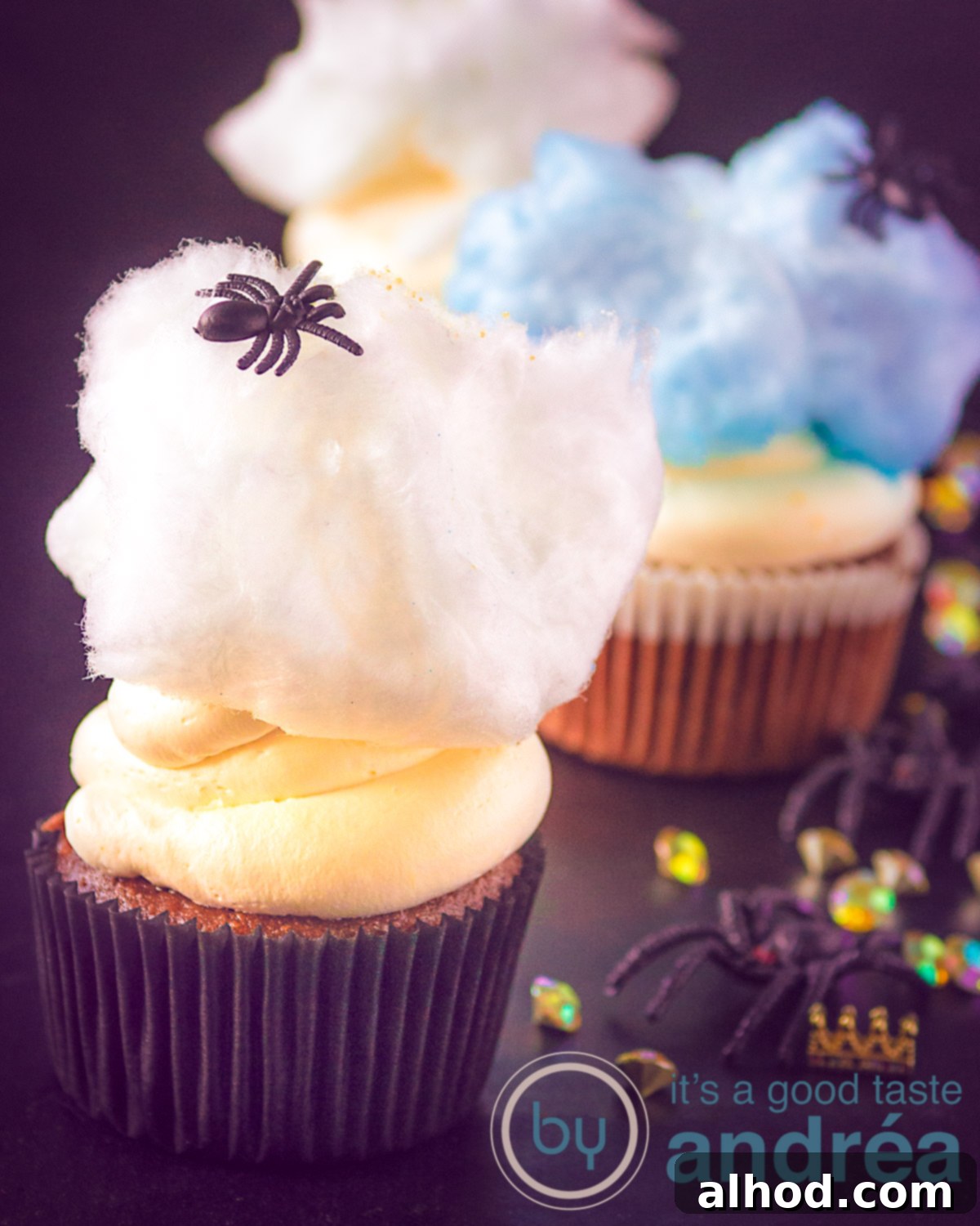Spooktacular Mascarpone Cream Cupcakes 3 Spider cupcakes with creamy mascarpone frosting and wisps of cotton candy, perfect for a spooky Halloween treat.
