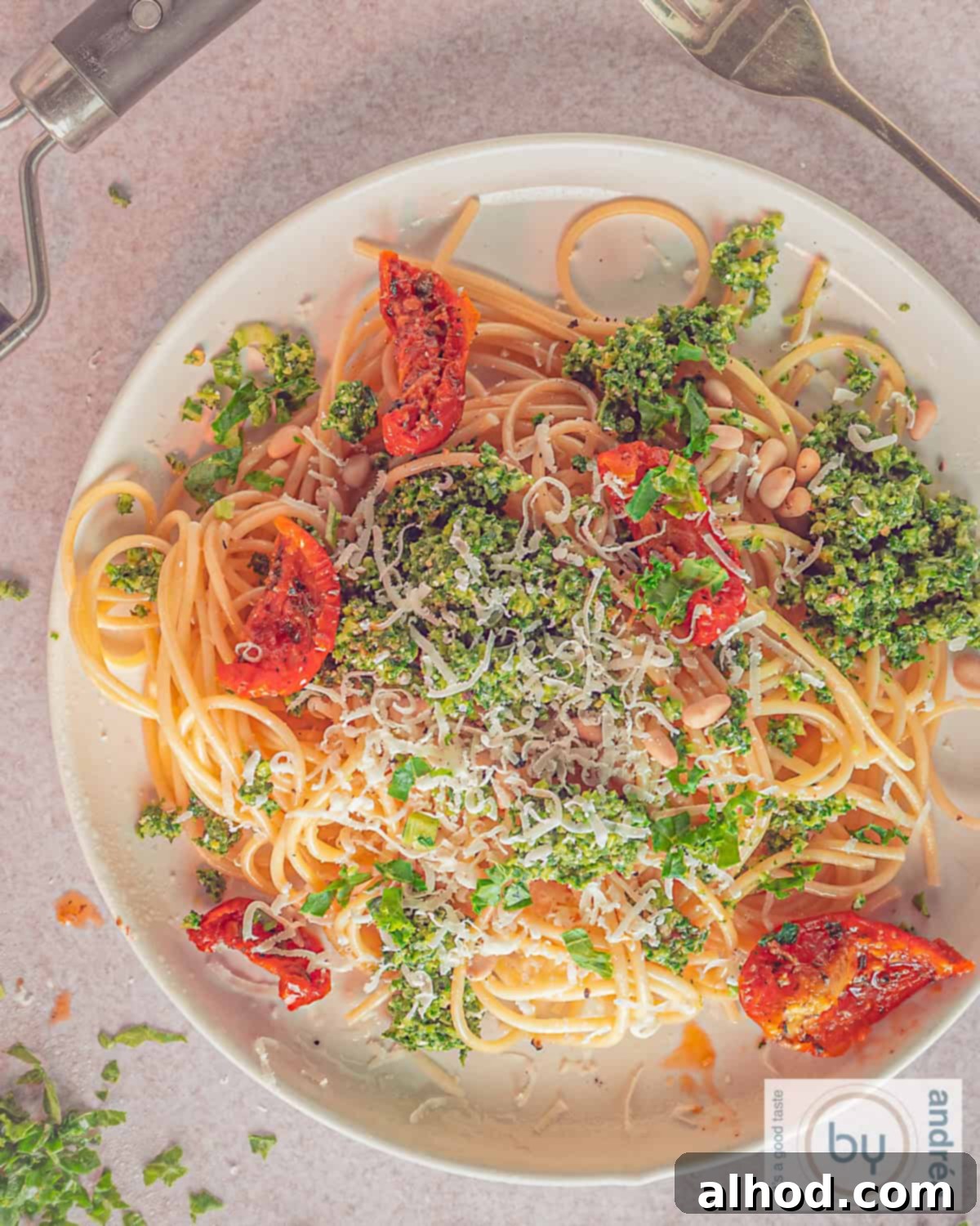 Vibrant Kale Pesto Pasta 5 A plate from above with spaghetti and kale pesto, sun-dried tomatoes on a light background.