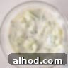 A bowl filled with a creamy yogurt marinade, freshly mixed with cucumber and dill, ready for chilling in the refrigerator to develop its full flavor.