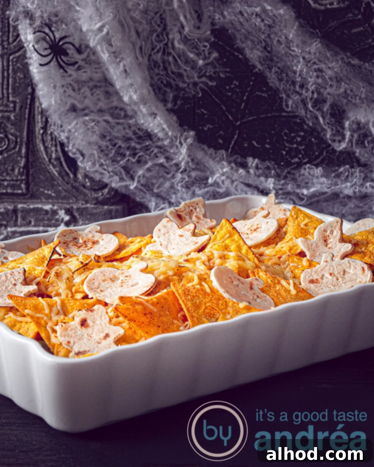 Loaded Chicken Nacho Bake 2 A white casserole filled with chicken, green beans, tomatoes and topped with nachos tortilla and cheese