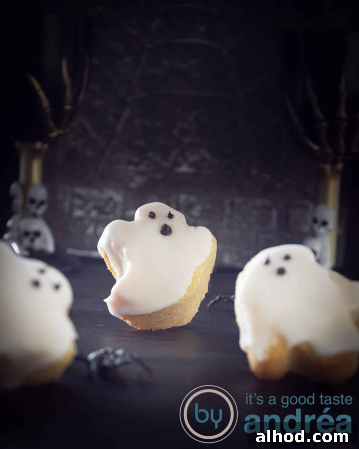 Grinning Ghost Halloween Cupcakes 2 Three cute ghost cupcakes on a dark surface in Halloween style, ready for a spooky celebration