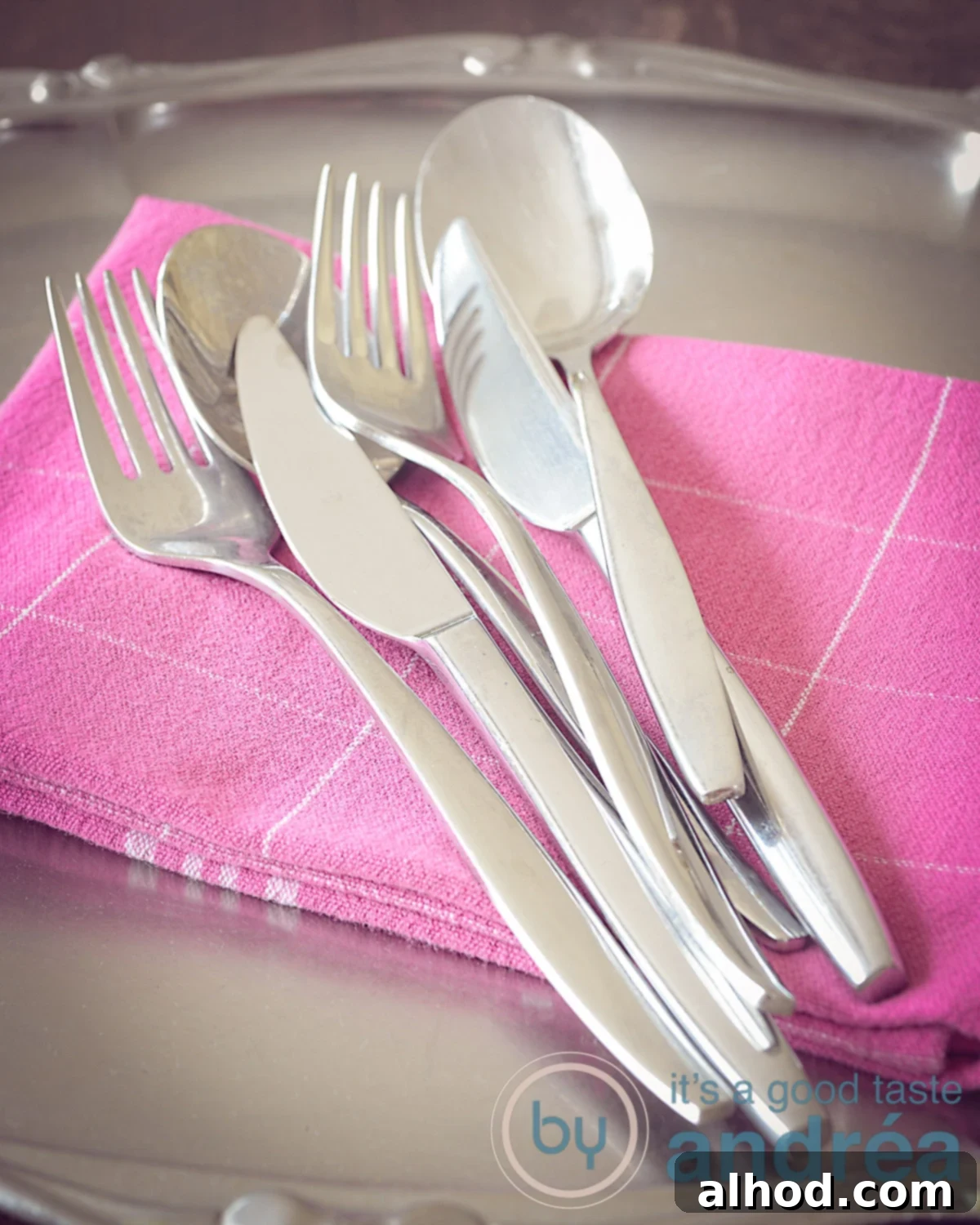 Sparkling Dishes, Zero Stress 6 Cutlery on a pink towel on a grey plate