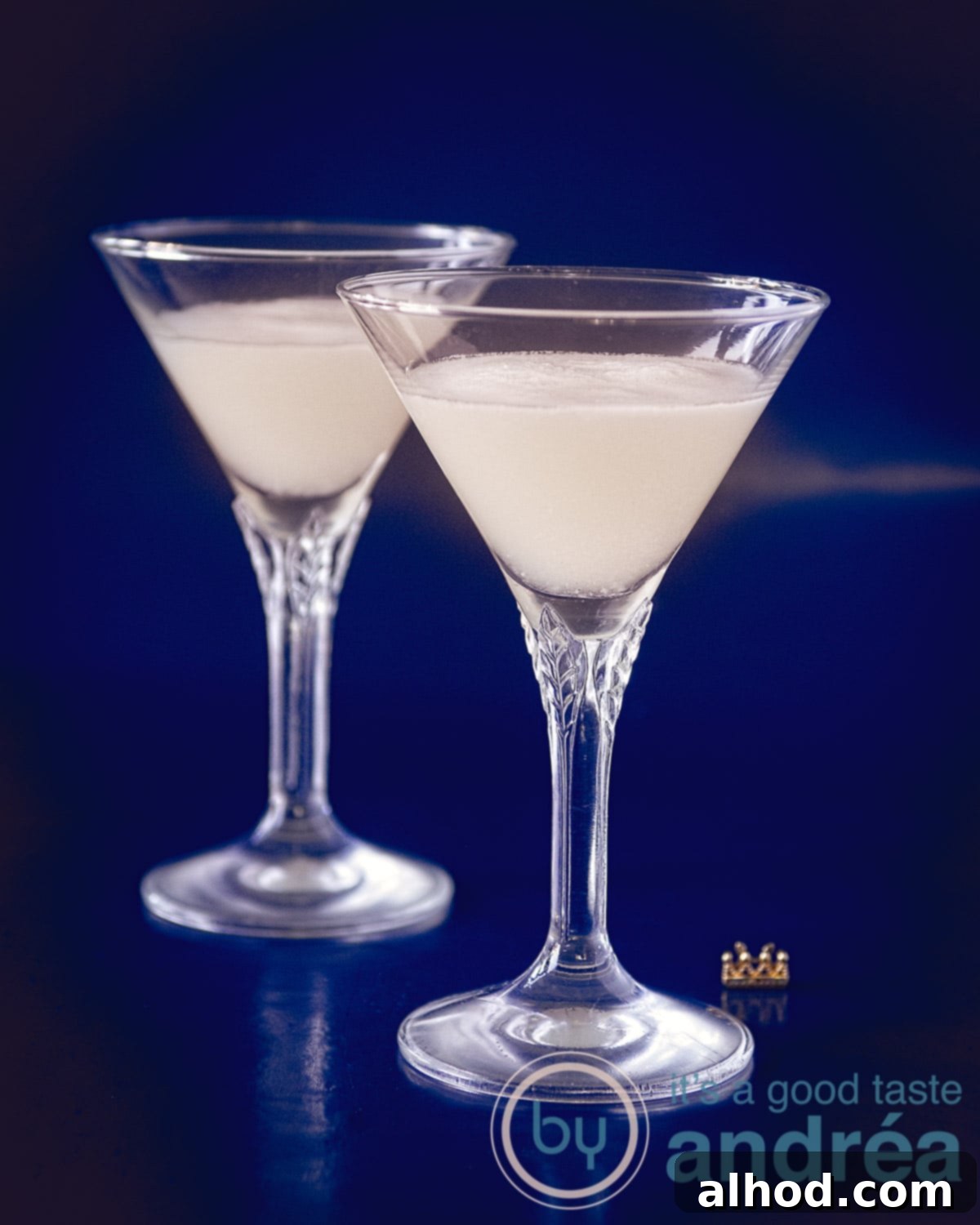 The Perfect Sherry Sour 2 A vibrant Sherry Sour cocktail in a delicate crystal glass, garnished with an elegant lemon twist, beautifully showcasing its creamy, frothy head.