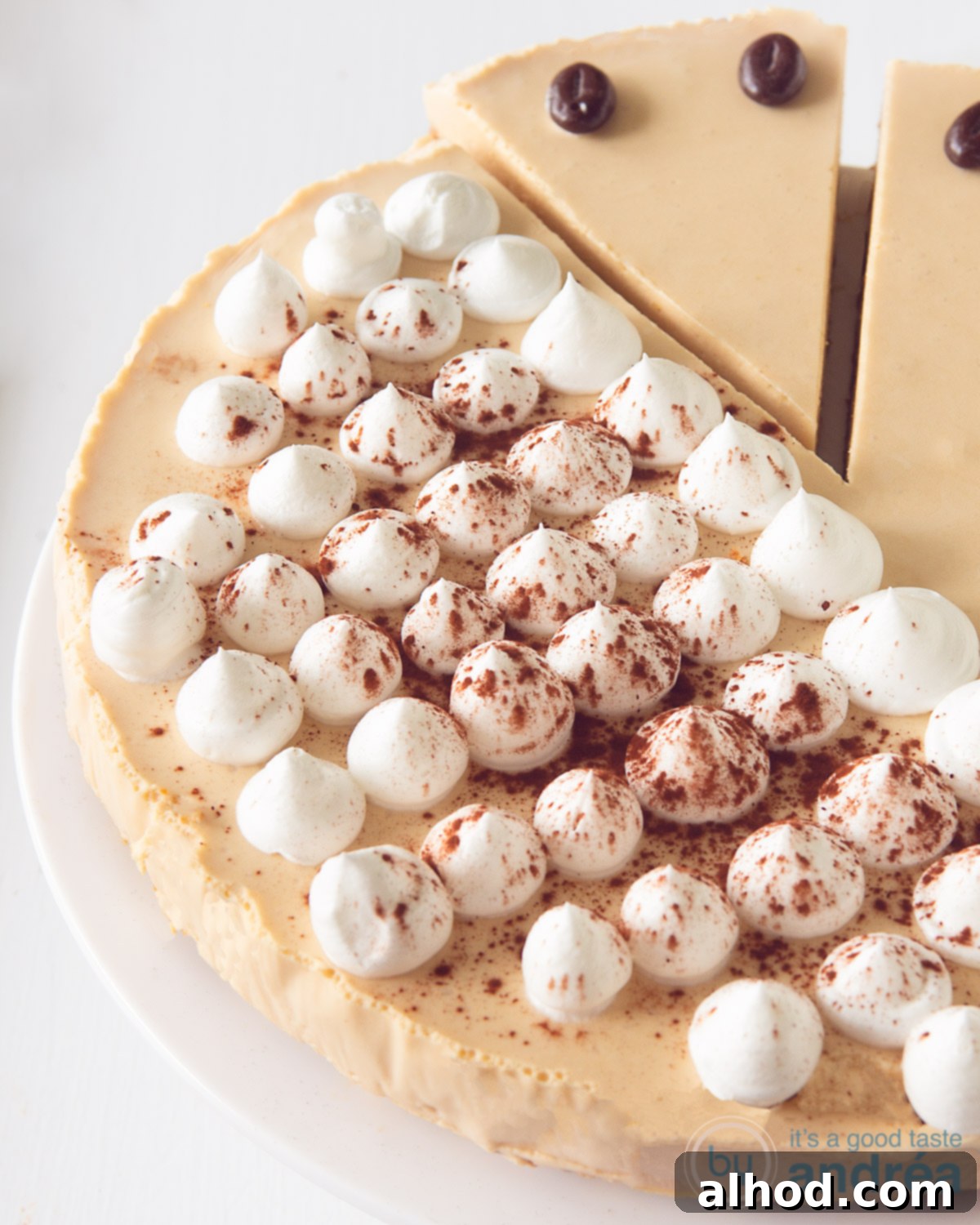 Irish Coffee Cheesecake 4 A close-up and inviting photo of a perfectly sliced piece of Irish Coffee Cheesecake, revealing its beautiful layers and creamy interior, set against a pristine white background. The image is tagged for Pinterest with relevant dessert keywords.