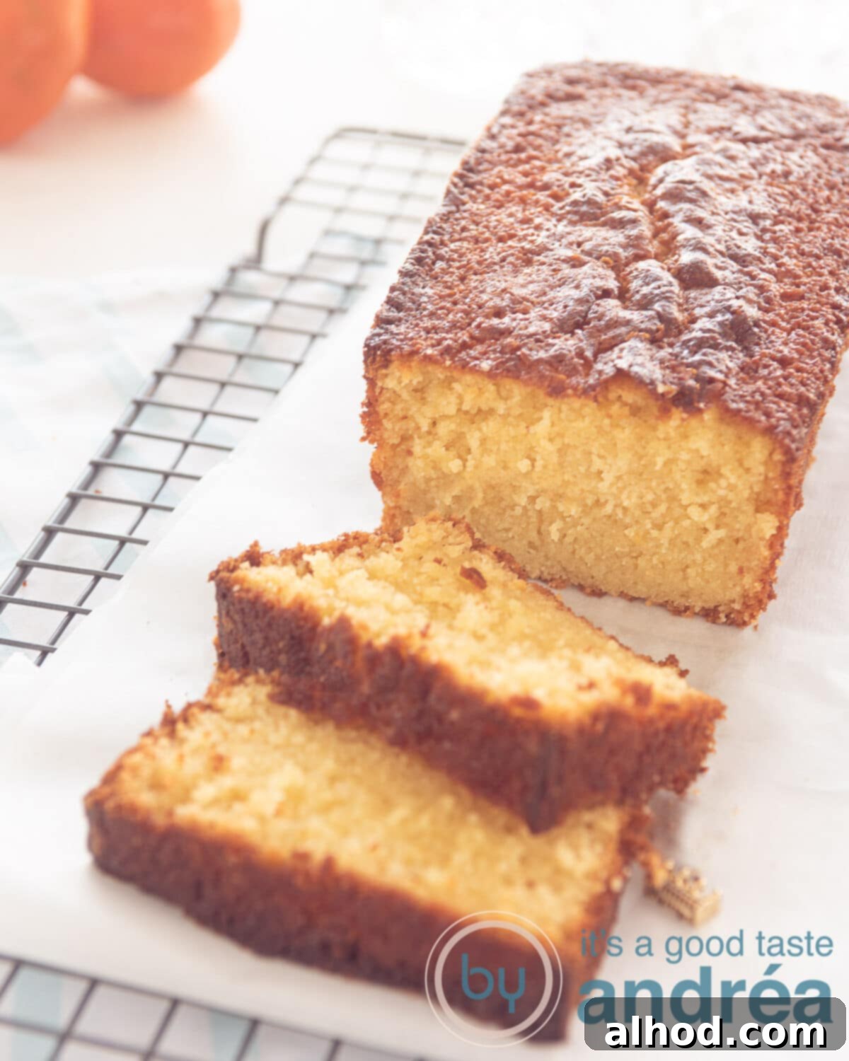 Moist Tangerine Yogurt Pound Cake 8 tangerine cake with slices on a rack, tangerines in the background