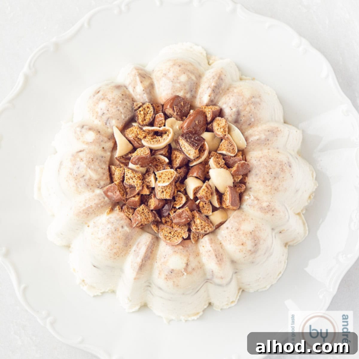 Dutch Pepernoten Pudding with Golden Caramel Swirl 4 A square photo from above of pudding with gingerbread on a white plate on a white background