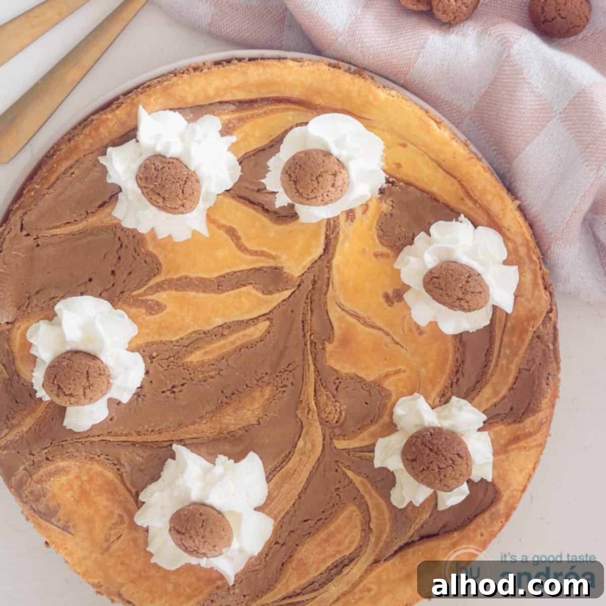 Sinterklaas Celebration Cheesecake 4 A square photo with a cheesecake with spiced nuts, Speculoos and whipped cream. A white background