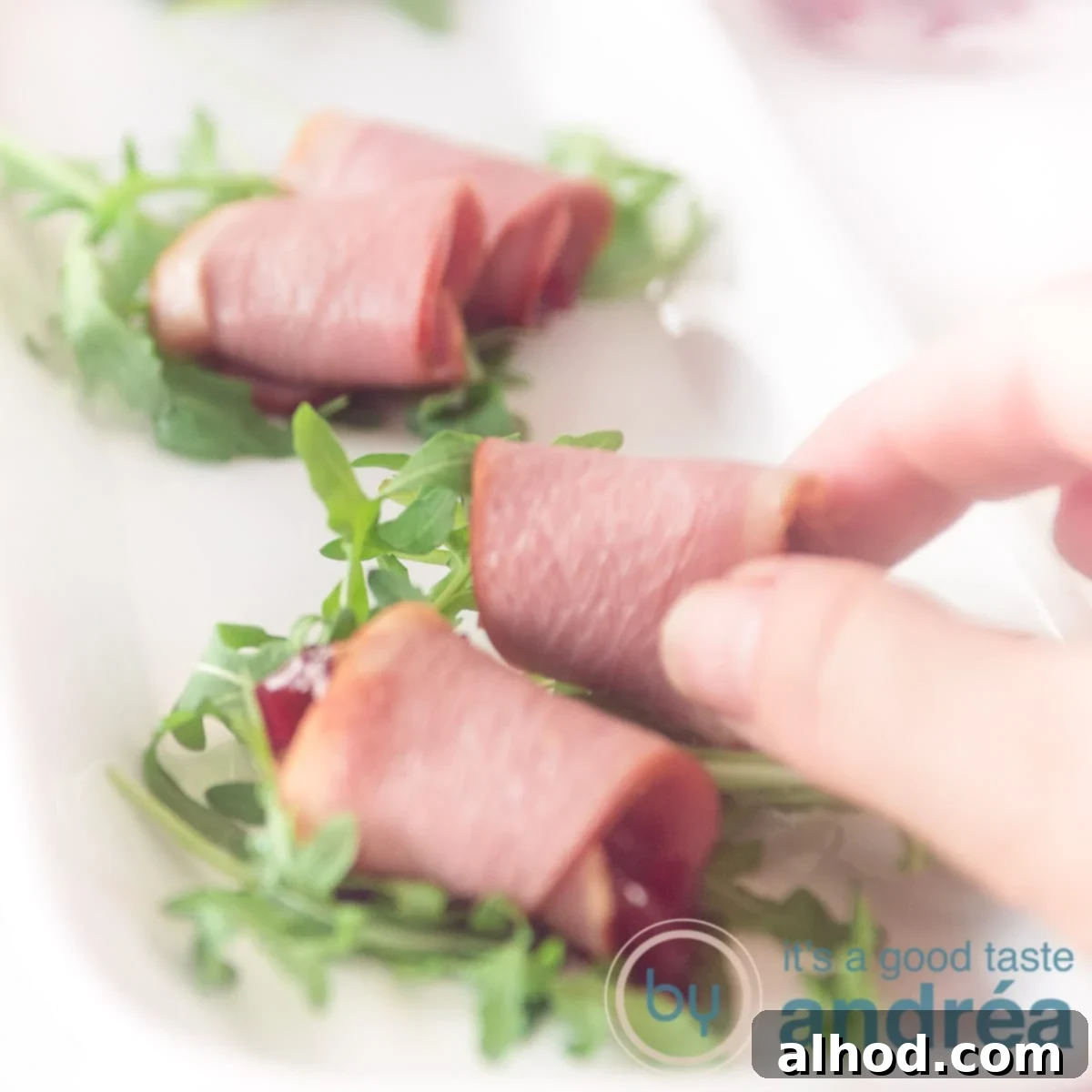 Duck Breast, Cranberry, Arugula Harmony 6 A square photo of three elegant amuse-bouche with smoked duck breast, cranberry compote, and arugula